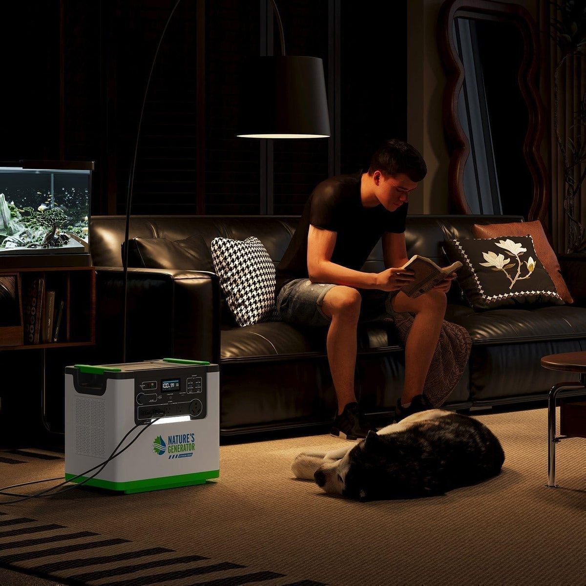 Person reading a book on a couch with a portable power station in the foreground